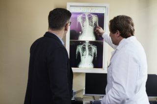 doctor looking at x-ray with patient